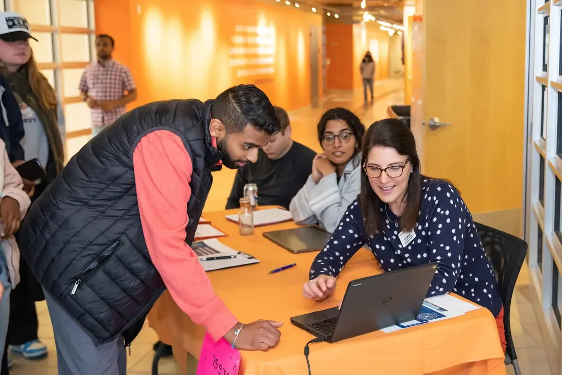 People standing around a computer.